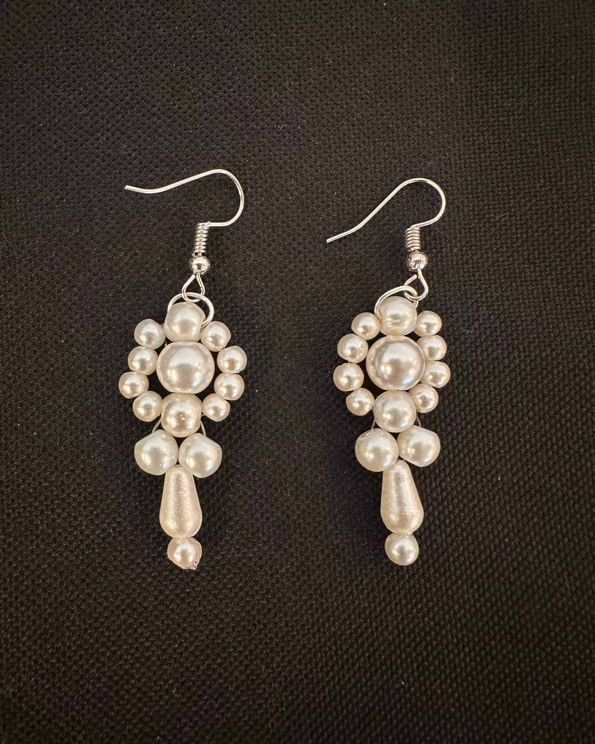 Pair of pearl earrings on a dark background