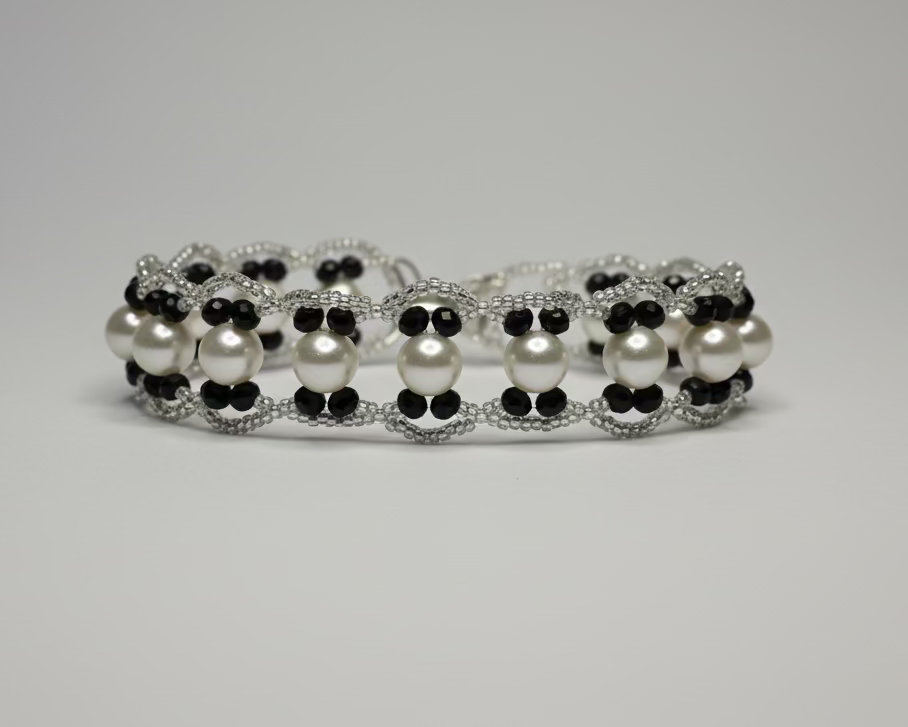 Pearl and black beaded bracelet on a Zarnoor branded card